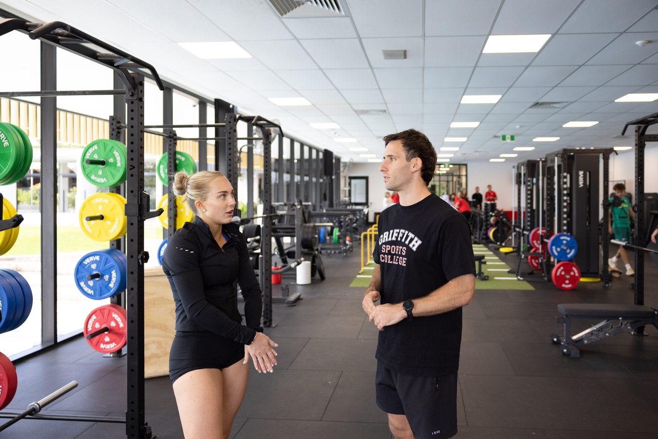 A coach and athlete on the Griffith High Performance floor.